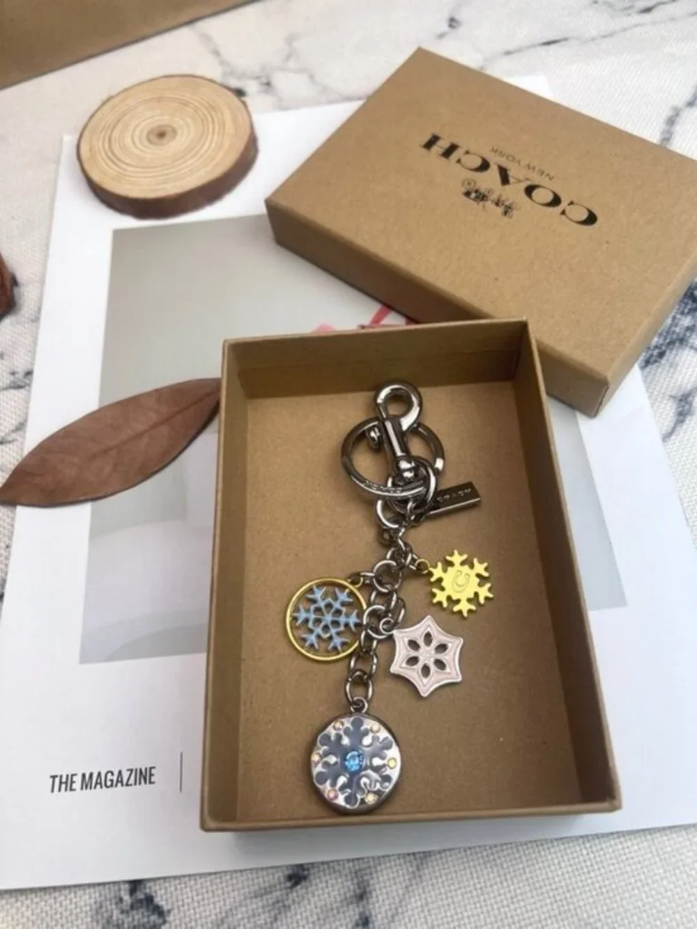 Coach Silver-Tone & Light Blue Snowflake Charm Keychain with Gold Accent